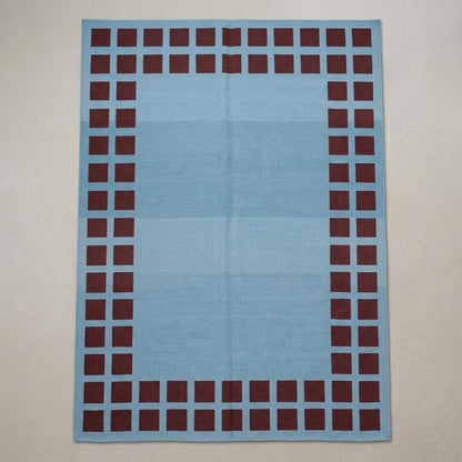 Handwoven sky blue dhurrie rug with maroon square border flatweave design