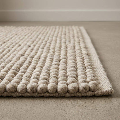 Handwoven pebble weave wool area rug in ivory beige with textured chunky loops for living room decor