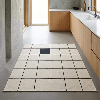 Ivory and charcoal grid flatweave wool rug with minimalist windowpane pattern in modern living room