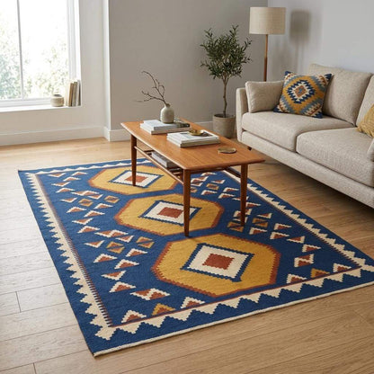 Handwoven blue kilim rug with golden hexagon medallions on indigo background and ivory border