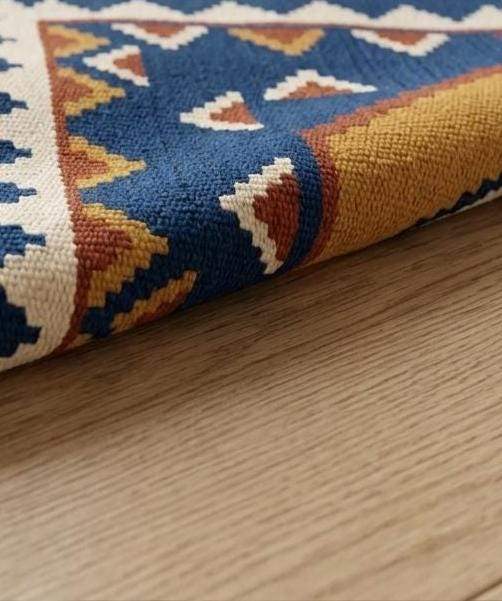 Blue kilim rug with gold geometric medallions on indigo field and ivory border flatweave wool decor