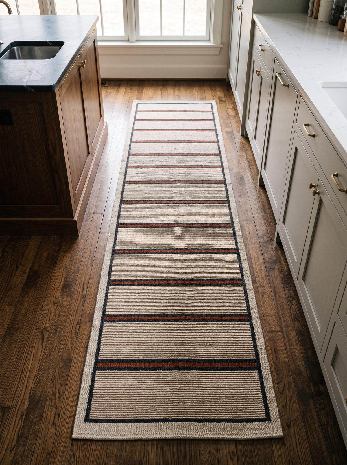 Handwoven wool flatweave runner rug with ivory, navy, and rust stripes for kitchen or hallway use