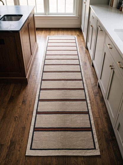 Handwoven wool flatweave runner rug with ivory, navy, and rust stripes for kitchen or hallway use