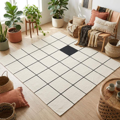 Ivory and charcoal grid wool flatweave rug with clean windowpane pattern in minimalist living room setting