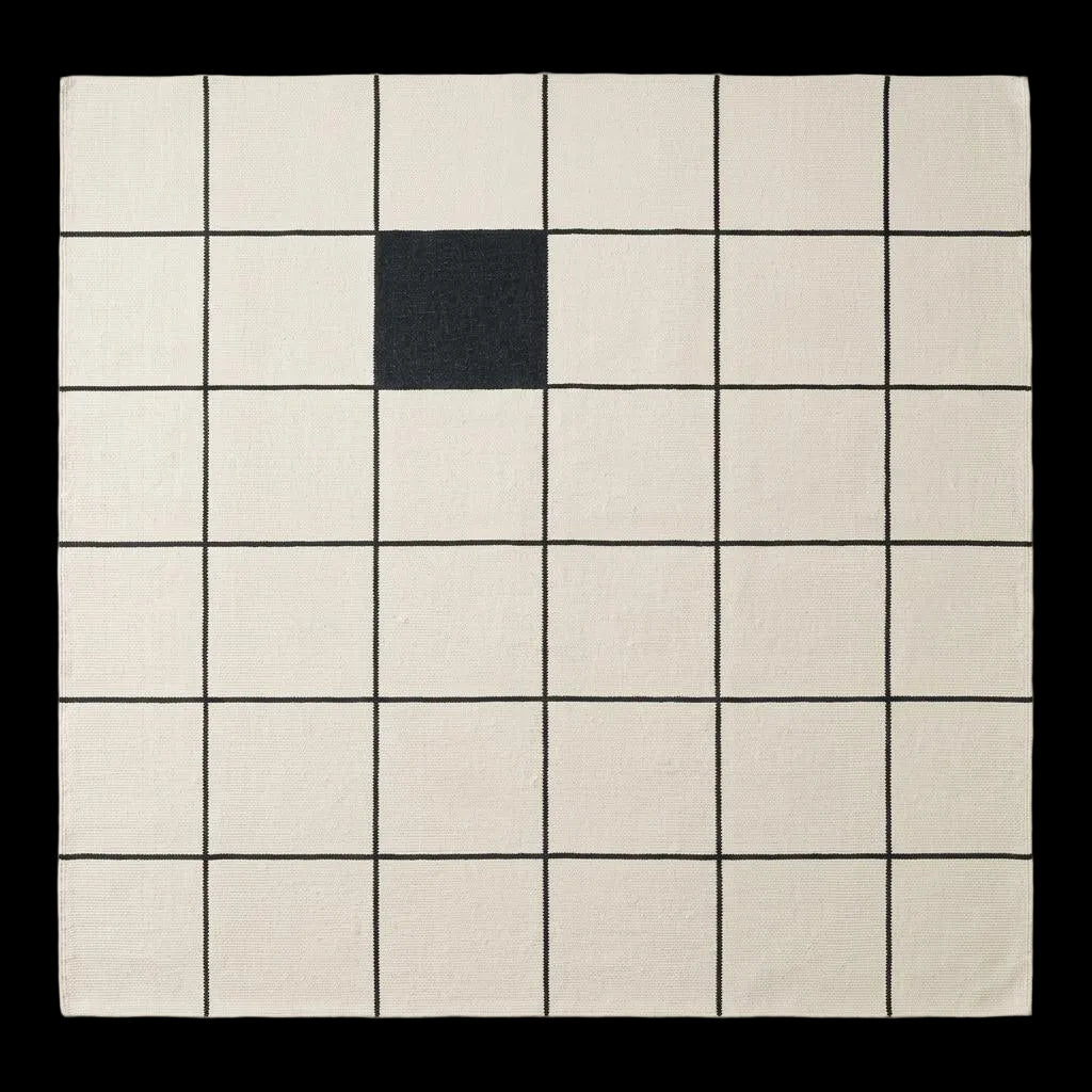 Ivory and charcoal grid wool flatweave rug with windowpane pattern in modern minimalist living room