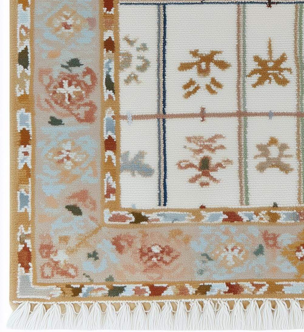 Ivory grid floral area rug with pastel border and fringed edges on stone floor