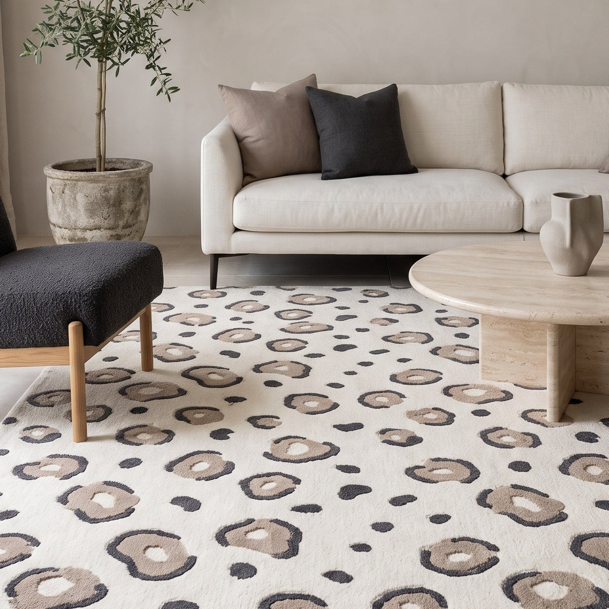 Ivory Leopard Rug with a creamy ground and taupe rosettes outlined in charcoal, featuring a plush sculpted pattern