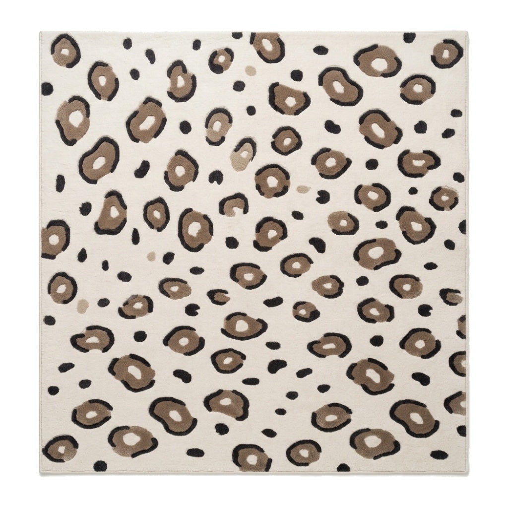 Ivory Leopard Rug with a creamy ivory field, taupe irregular spots outlined in charcoal, and scattered black markings