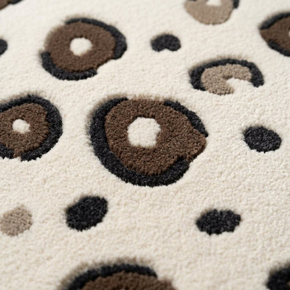 Ivory Leopard Rug with a plush ivory surface, raised taupe rosettes outlined in charcoal, and scattered dark spots