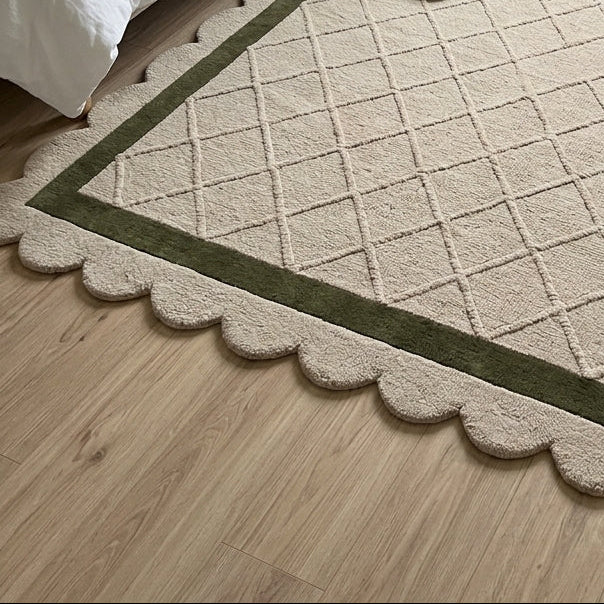 Ivory & Olive Lattice hand-tufted wool rug in cream with a carved diamond pattern, olive border and scalloped edge.