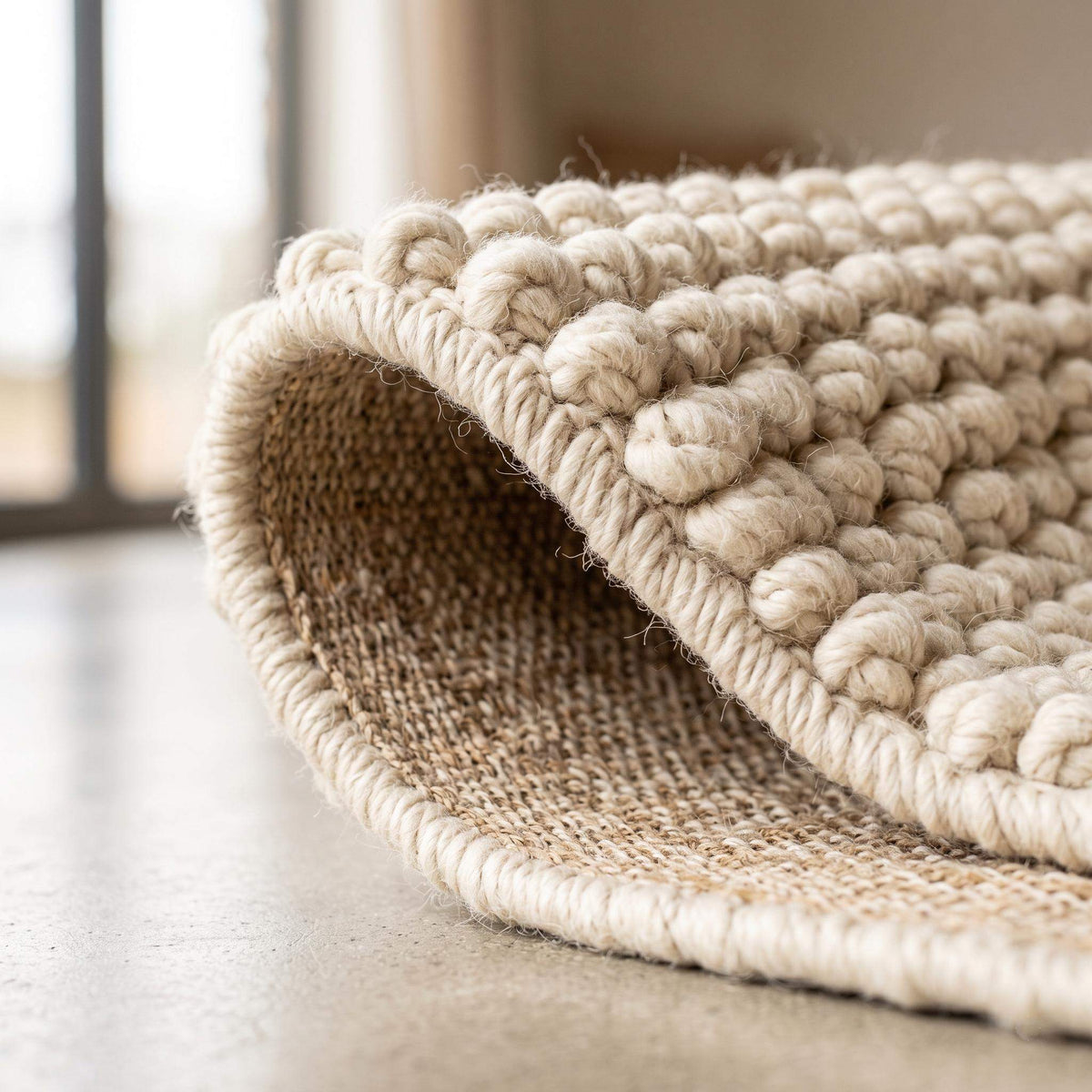 Ivory textured hand-woven wool rug with chunky bobble loop weave for neutral living room decor