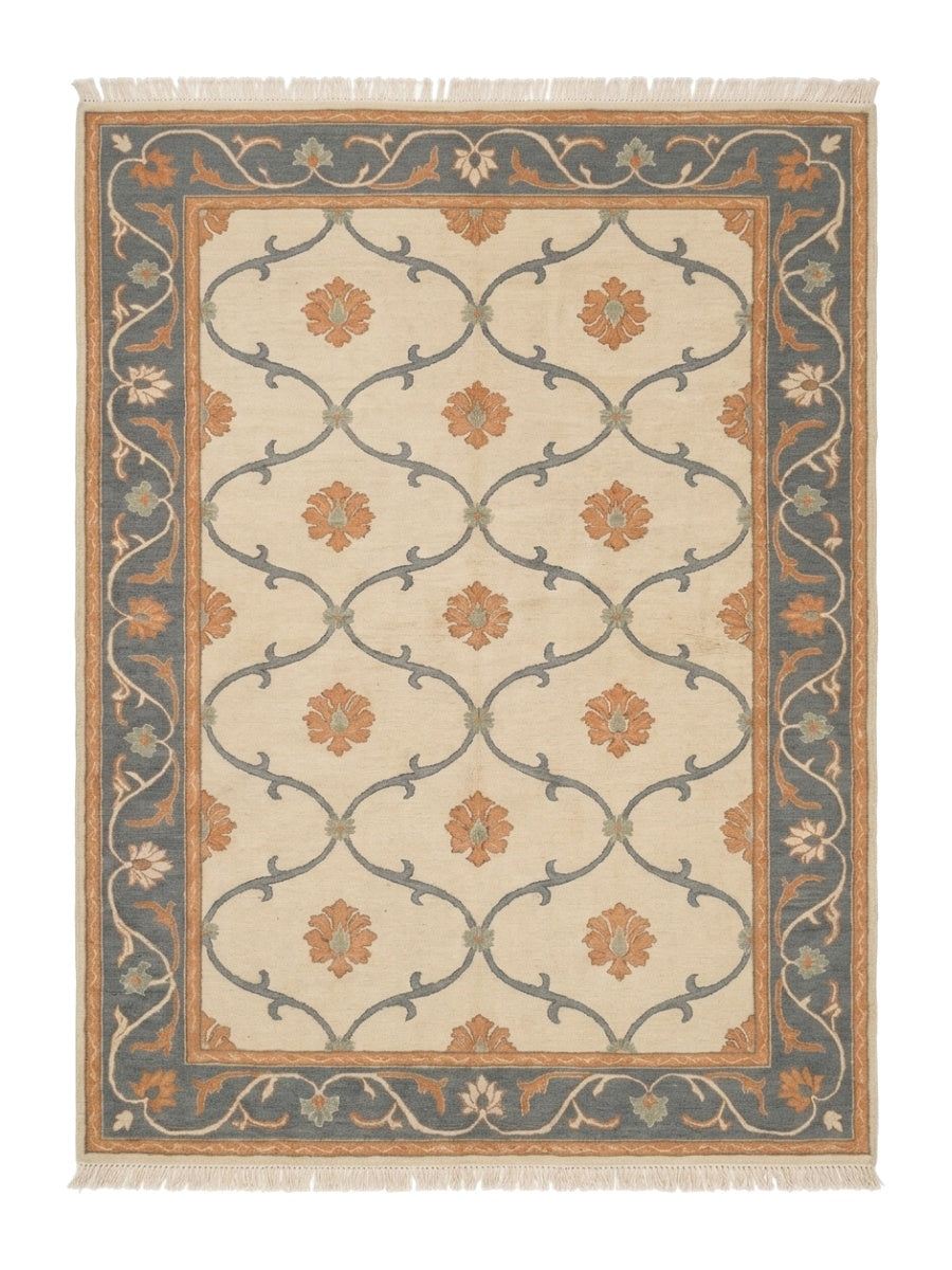 Ivory Trellis Rug with a soft ivory wool field, slate blue vine lattice, peach floral motifs, and ornate blue border
