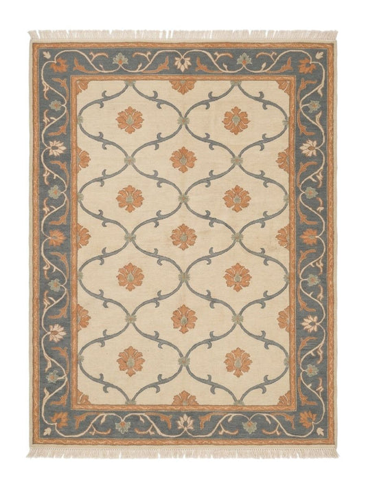 Ivory Trellis Rug with a soft ivory wool field, slate blue vine lattice, peach floral motifs, and ornate blue border
