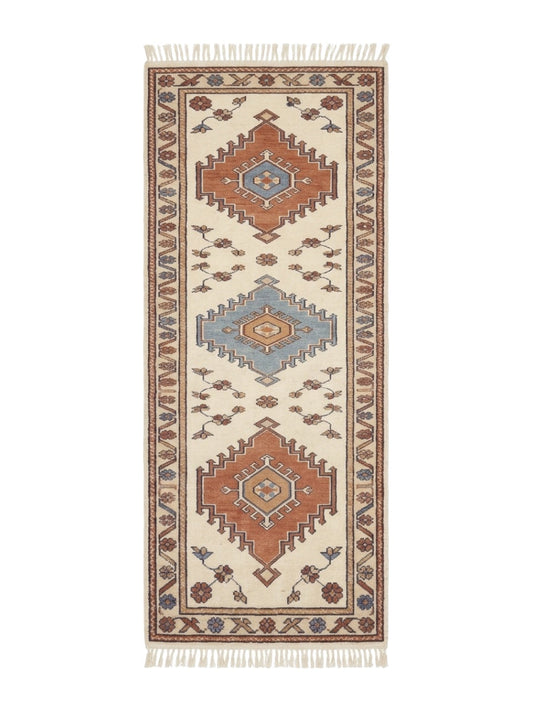 Ivory Tribal Runner Rug in wool, with terracotta and blue stepped diamond medallions, floral sprays and fringed ends