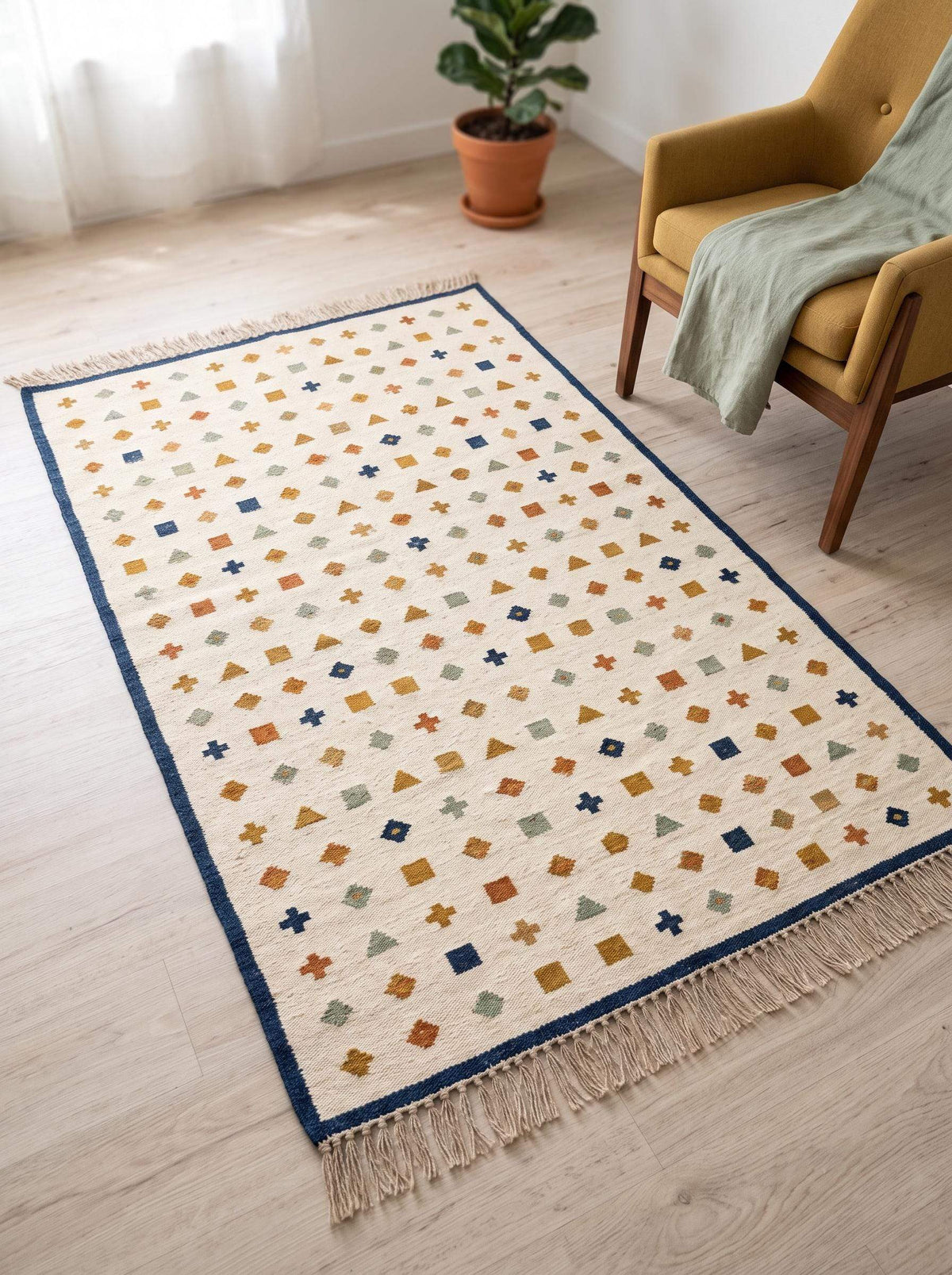 Ivory wool flatweave kilim rug with navy border and geometric motifs in living room