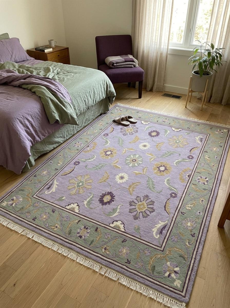 Lavender Floral Rug in wool with a pale lilac field, multicoloured floral motifs, sage green vine border and fringe