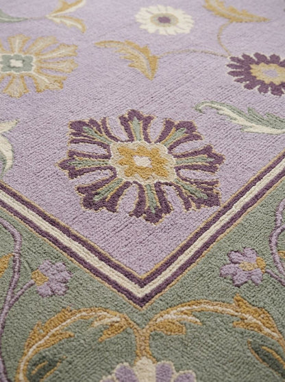 Lavender Floral Rug with a textured wool pile, golden and plum blossoms, and a sage green floral border