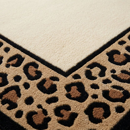 Leopard Border Rug in ivory wool with a tan, black and caramel spotted border and crisp black edging