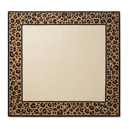 Leopard Border Rug in ivory wool with a plain centre, tan and caramel leopard print border, and crisp black lines
