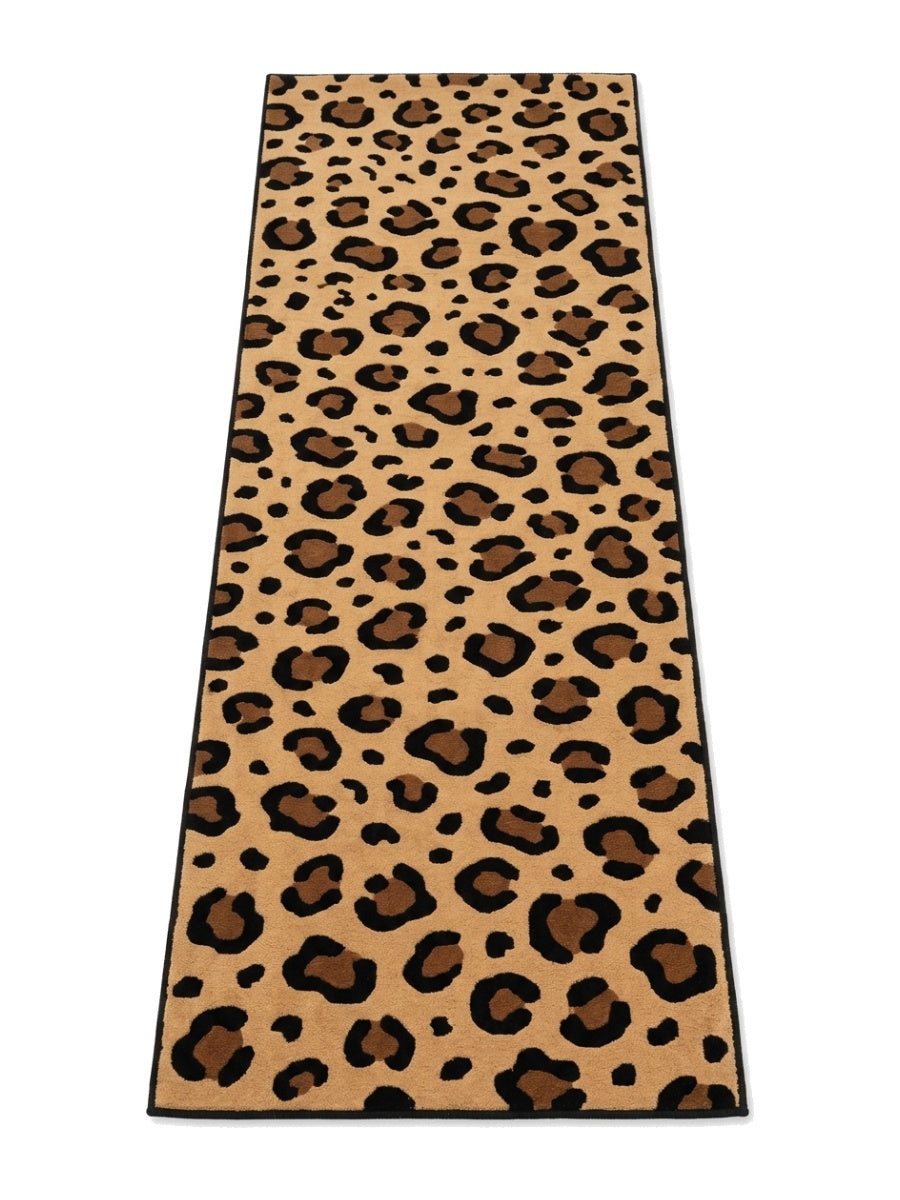 Leopard Print Runner Rug in tan with black and brown rosette spots, finished with a slim black bound edge