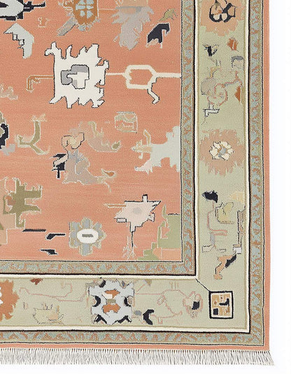 Hand-knotted modern abstract peach wool rug with sage green geometric border and multicolor accents