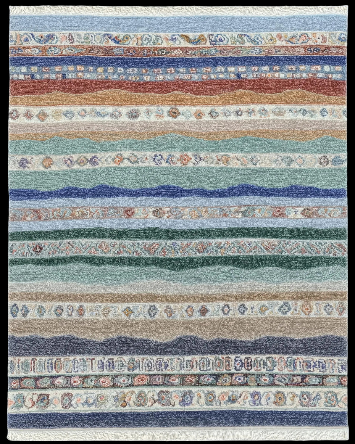 Multicolor striped area rug with horizontal bands, diamond motifs, and fringe in coastal blues and earthy terracotta tones