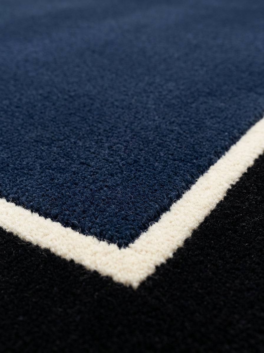Navy Blue Border Runner Rug with a deep navy wool pile, ivory pinstripe and wide black border