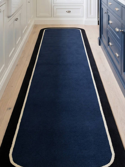 Navy Blue Border Runner Rug with a solid navy pile, fine ivory pinline, wide black border and rounded ends