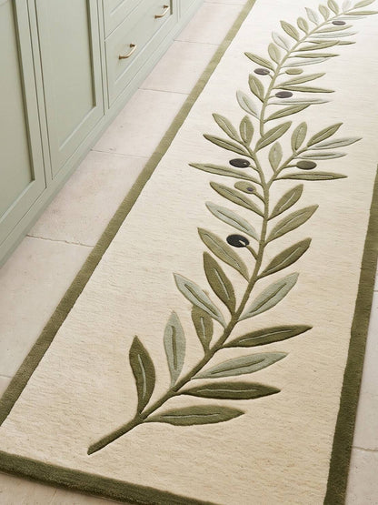 Olive Branch Runner Rug in ivory wool with an olive green border and a carved branch, sage leaves and dark olives