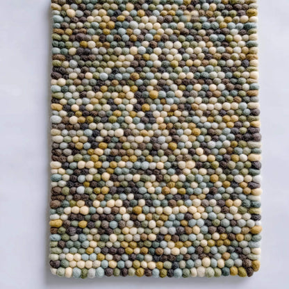 Handmade Olive & Mint Pebble Mat with textured felt wool balls in green, mint, cream, and brown tones for cozy home decor
