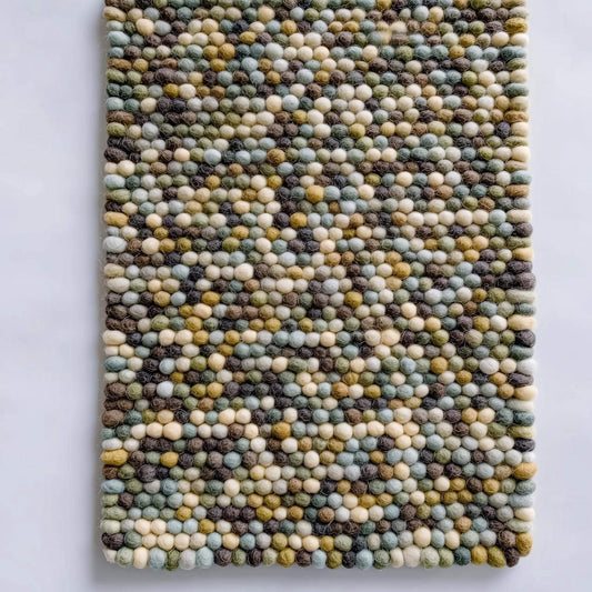 Handmade Olive & Mint Pebble Mat with textured felt wool balls in green, mint, cream, and brown tones for cozy home decor