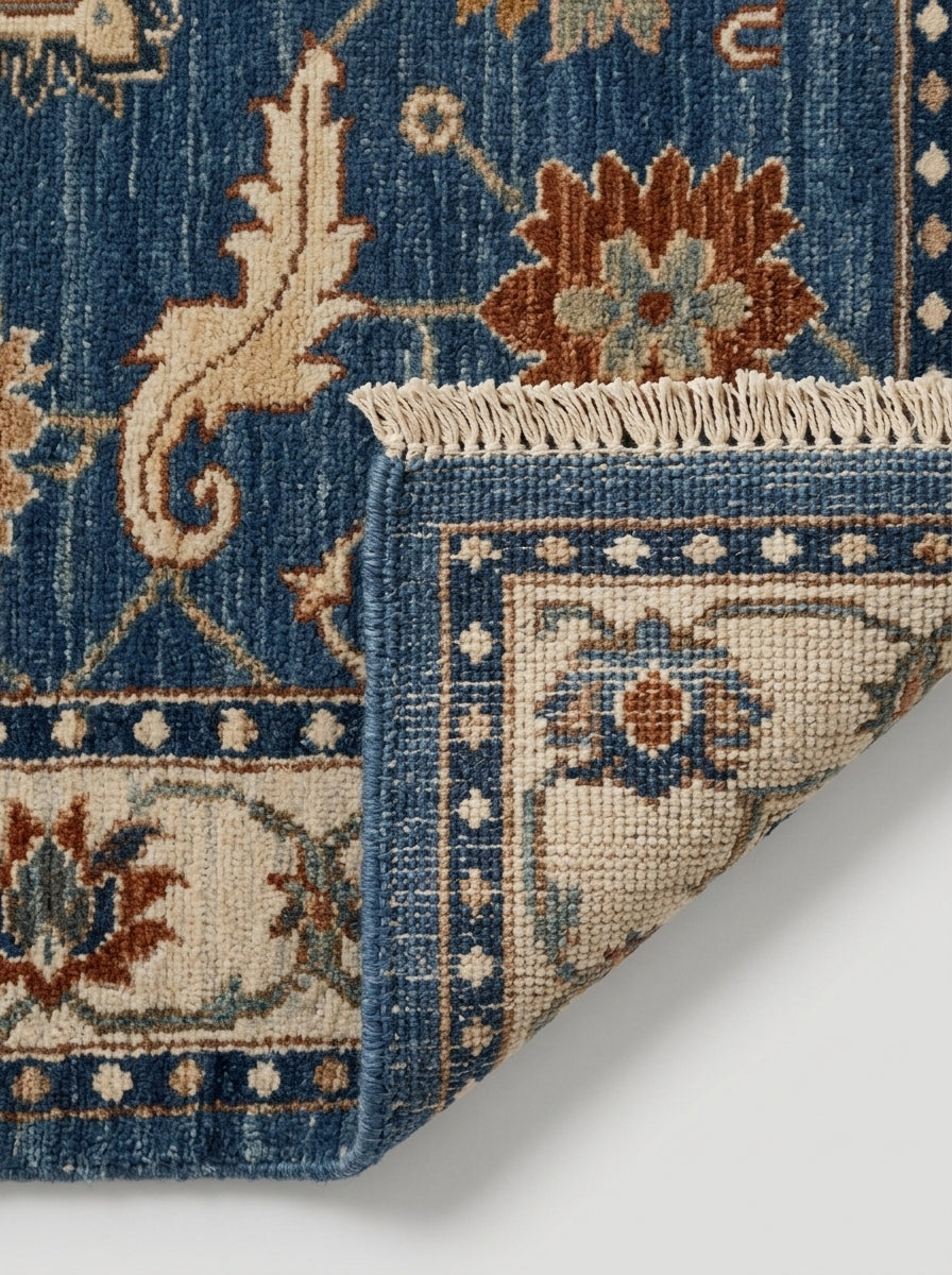 Oushak Hand Knotted Rug in blue wool with ivory floral border, rust and sage blossoms, and fringed edge
