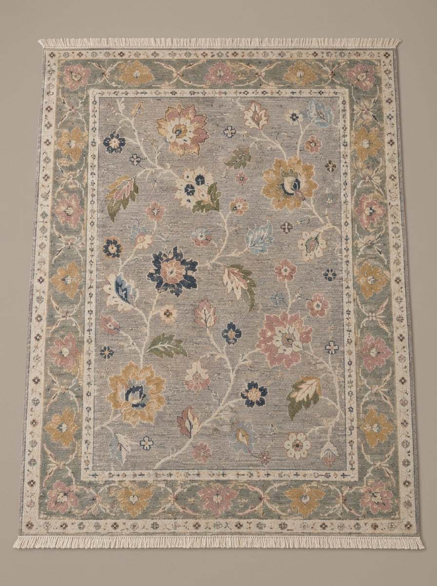 Oushak Hand Knotted Rug in dove gray wool with multicolored floral vines and a sage green palmette border