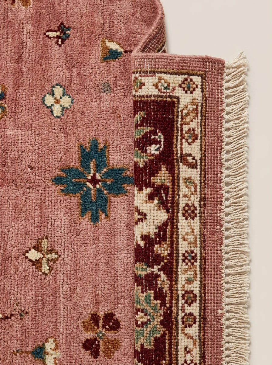 Oushak Hand Knotted Rug in dusty rose wool, with scattered multicolour florals, burgundy border and fringe.