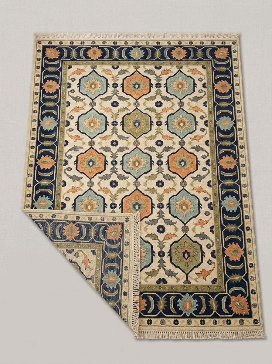 Oushak Hand Knotted Rug in ivory wool with navy-bordered hexagon medallions in aqua, orange and olive