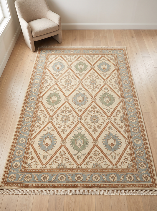 Oushak Hand Knotted Rug in ivory wool with rust diamond lattice, sage and blue floral motifs, and a powder blue rosette border