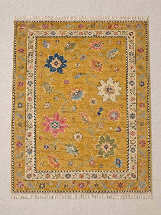 Oushak Hand Knotted Rug in mustard yellow wool with scattered multicolour floral motifs, ivory rosette border and fringe
