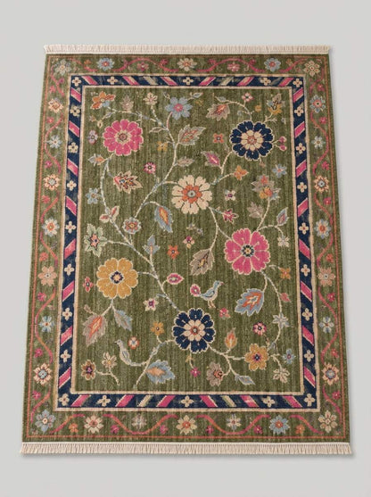 Oushak Hand Knotted Rug in olive green wool with pink, navy and mustard flowers, trailing vines, birds and striped border
