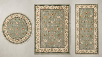 Oushak Hand Knotted Rug in muted sage green wool, with scattered floral motifs, an ivory vine border and teal guard bands.