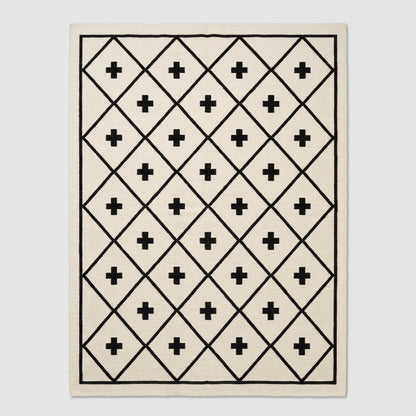 Southwestern Flatweave Wool Rug in ivory with a black diamond lattice, Swiss cross motifs, and slim border.