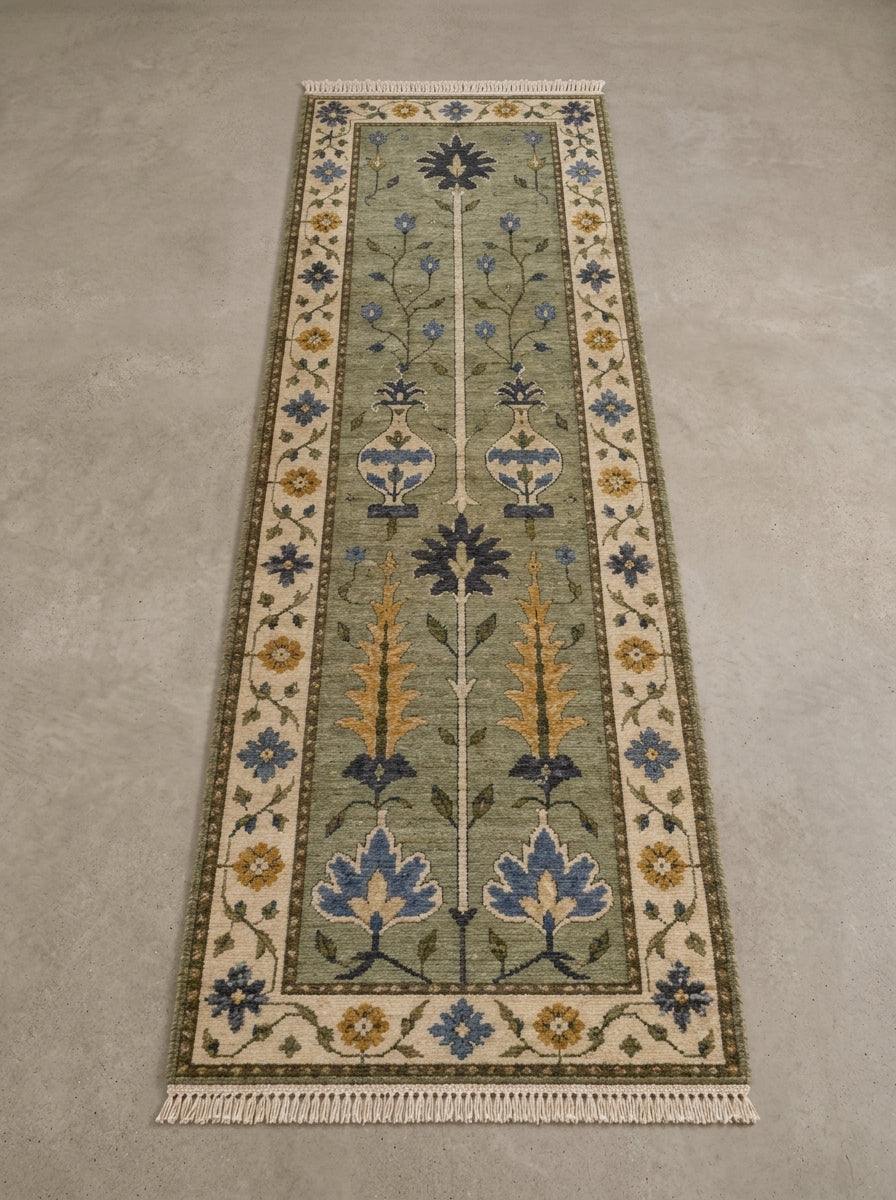 Hand Knotted Oushak Runner Rug in sage green wool, with floral vase motifs, blue and mustard accents, ivory border and fringe.