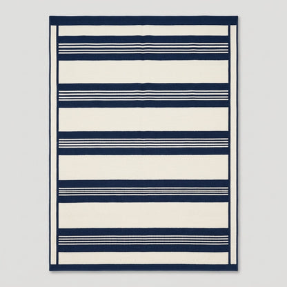 Southwestern Flatweave Wool Rug in navy and ivory, with bold horizontal bands, fine pinstripes, and a slim framed edge.