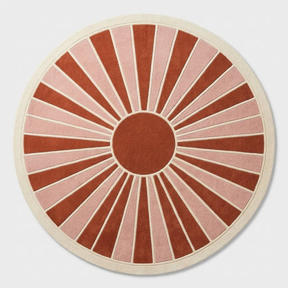 Oval Handmade Retro Rug in terracotta and blush pink wool, with ivory-outlined sunburst rays and a wide ivory border.