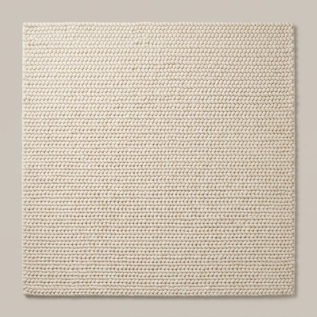 Chunky Wool Rug in ivory cream, with a thick, tightly braided knit texture and neatly aligned rows of loops.