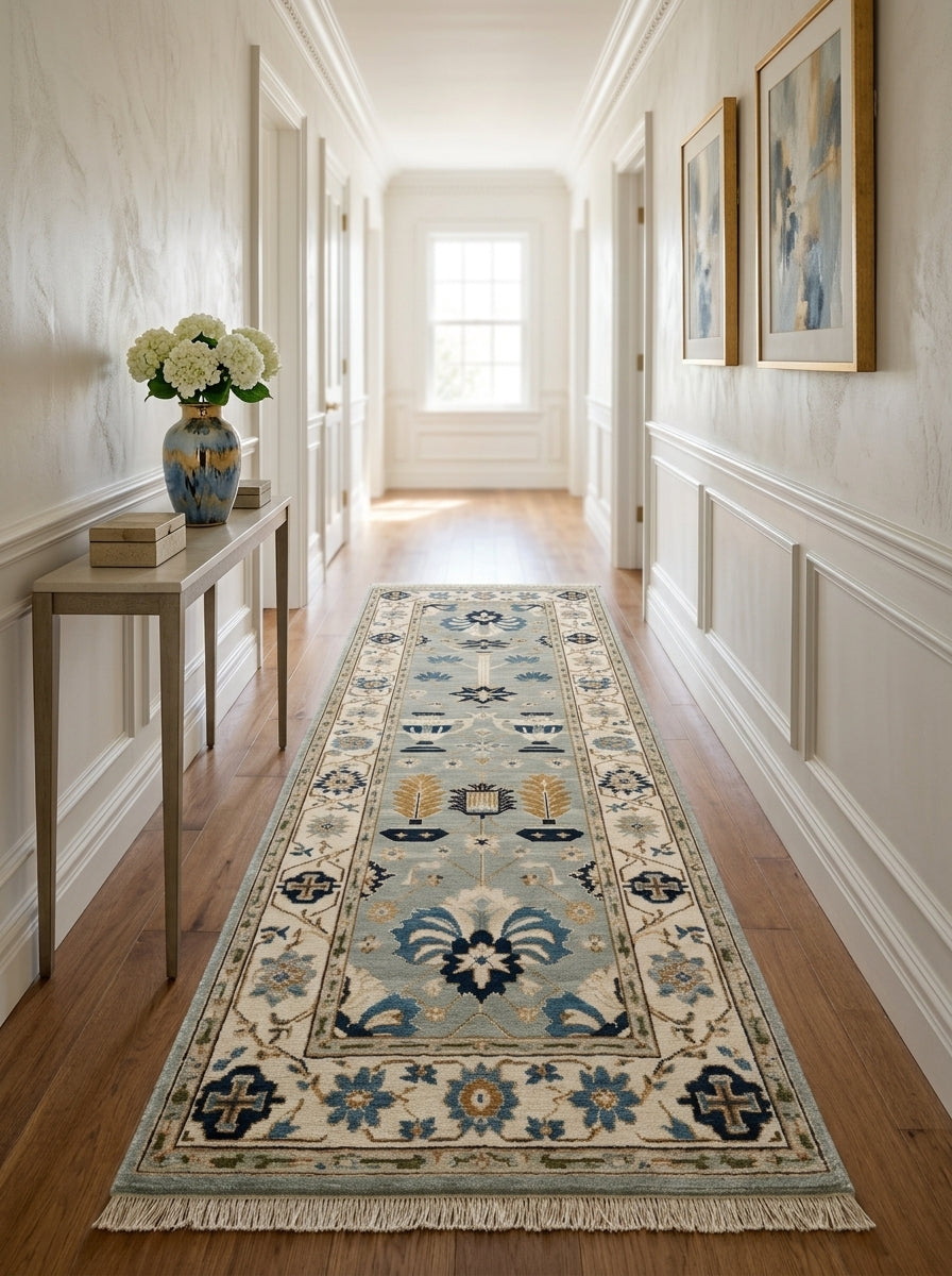 Hand Knotted Oushak Runner Rug in soft blue wool, with ivory floral border, navy and copper motifs, and fringed ends.