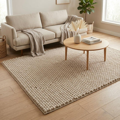 Chunky Wool Rug in oatmeal beige with a thick, handwoven surface of evenly spaced raised pebble rows and bound edges.