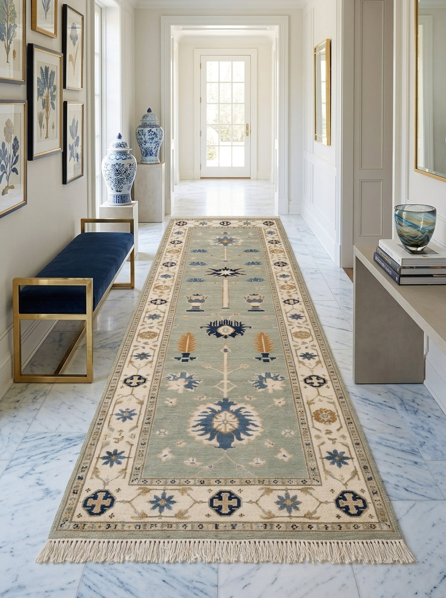 Hand Knotted Oushak Runner Rug in muted seafoam green wool, with ivory floral borders, blue and amber motifs, and fringe.