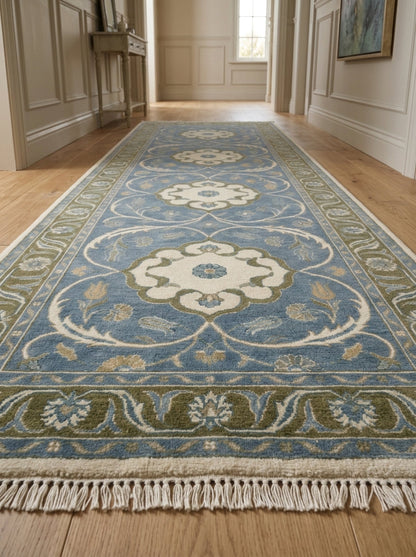 Hand Knotted Oushak Runner Rug in light blue wool, with ivory floral medallions, olive green scrolling border and fringe.