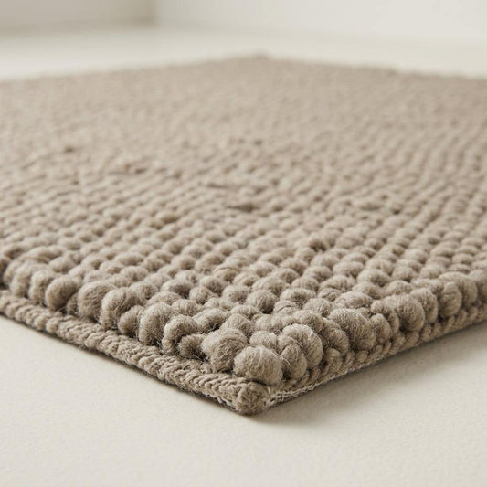 Chunky Wool Rug in taupe greige, with a thick handwoven surface of chunky rounded pebble knots and finished edges.