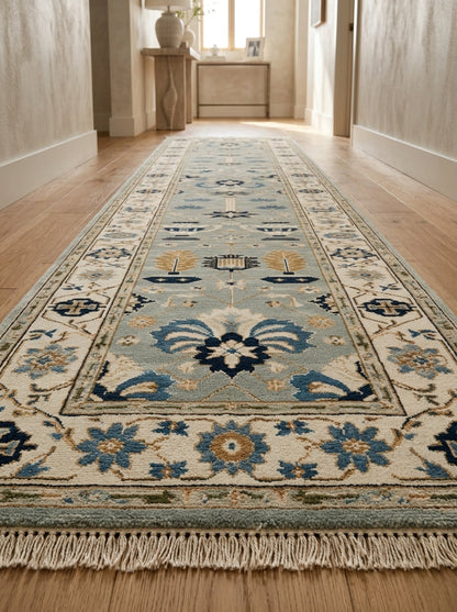 Hand Knotted Oushak Runner Rug in soft blue wool with ivory floral border, navy and copper motifs, and fringe.
